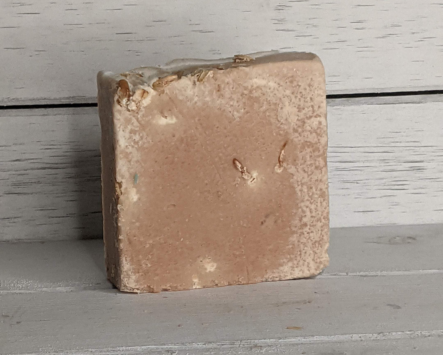 Brown rectangular stone on a gray wooden surface