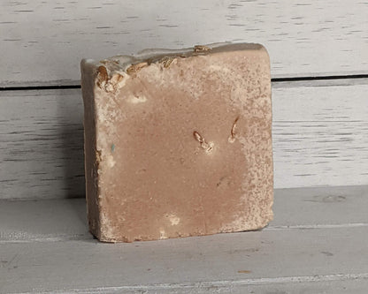 Brown rectangular stone on a gray wooden surface